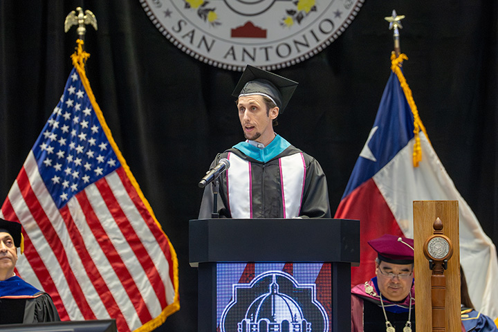 Forrest Cobb at Podium Giving Speech at Commencement